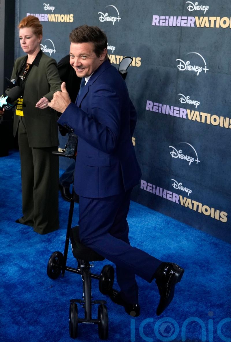 Jeremy Renner uses scooter and cane on first red carpet since snowplough injury