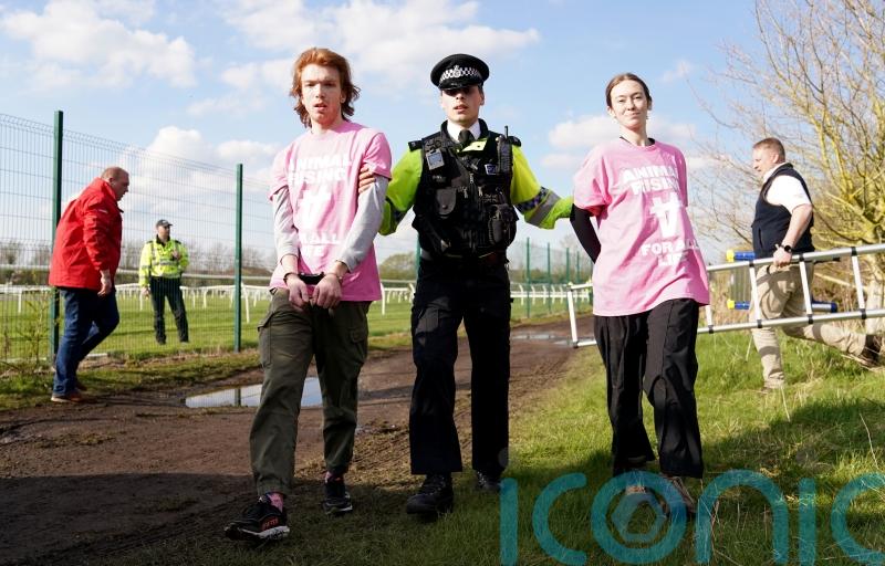 More than 100 arrested after protesters storm Grand National and delay race