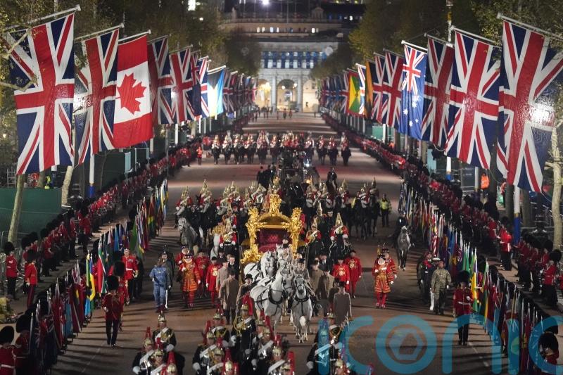 Early morning coronation rehearsal featuring state coaches staged in London