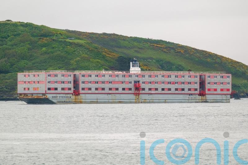 Migrant barge arrives in UK as docking port reportedly fears far-right protests