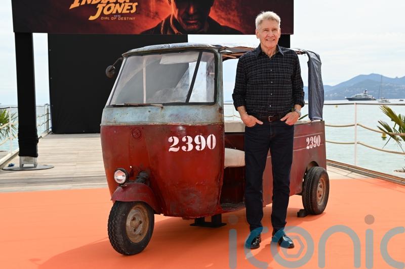Harrison Ford poses at Cannes ahead of world premiere for new Indiana Jones film
