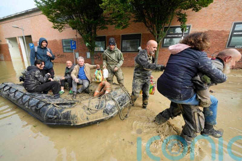 Death toll rises to 13 as rescue workers bid to reach towns cut off by floods