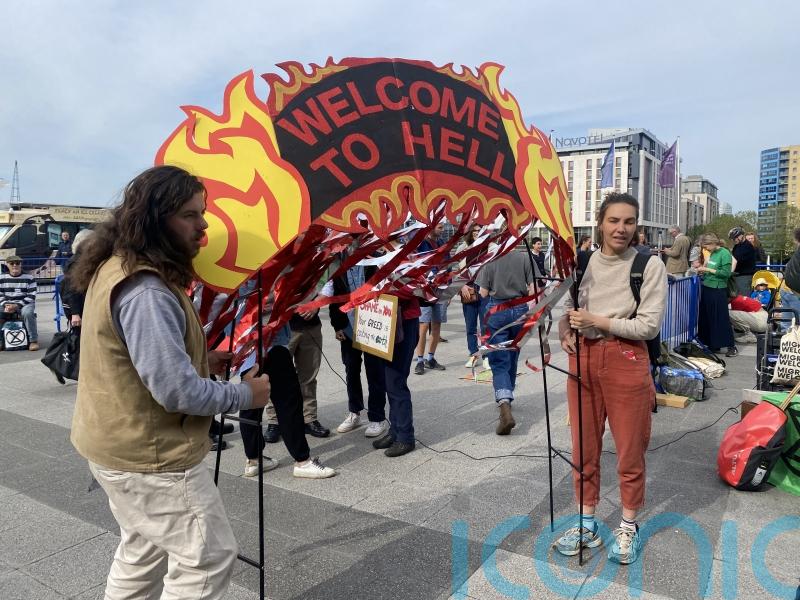 Climate change protesters try to storm the stage at tense Shell AGM