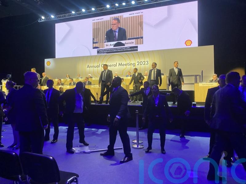 Climate change protesters try to storm the stage at tense Shell AGM