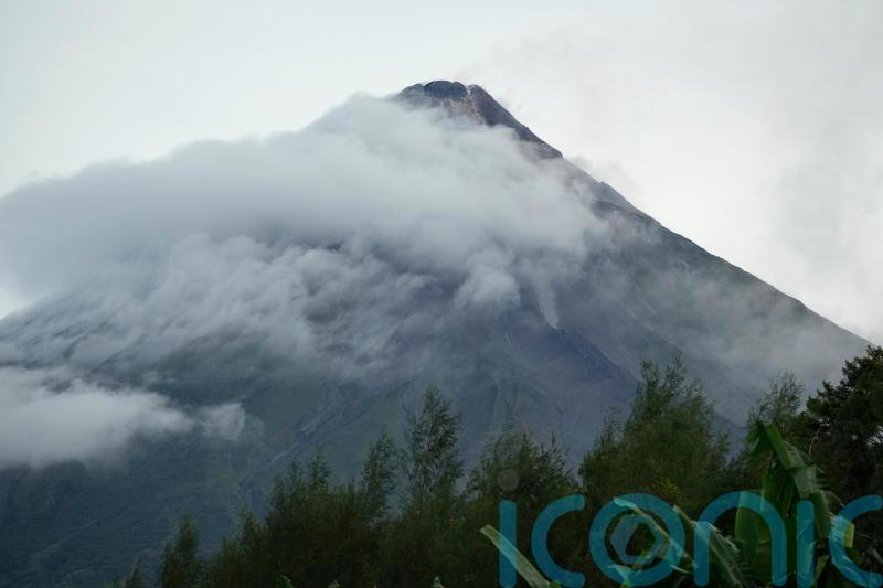 Rains unleashed by typhoon add to woes of thousands fleeing volcano