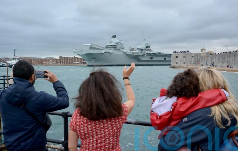 Well-wishers wave off Royal Navy aircraft carrier as it sails for sea trials