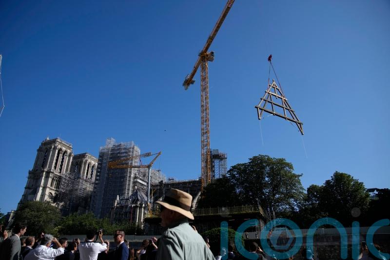 Paris crowds watch as oak trusses raised to roof of Notre Dame