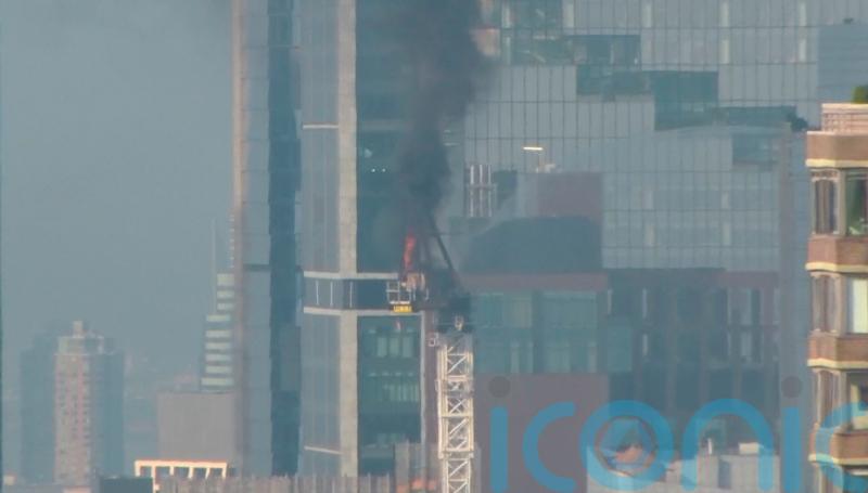 Pedestrians scatter as fire causes New York crane arm to crash to street