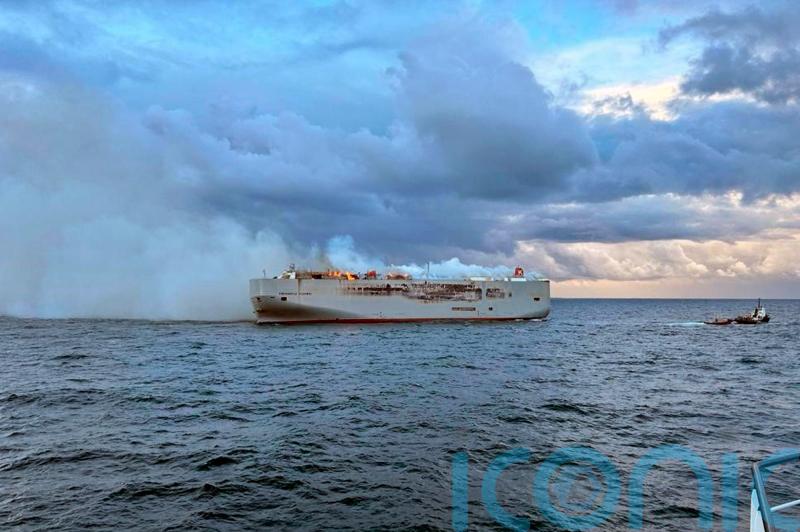 Crew member dies as fire on ship carrying 3,000 cars burns out of control