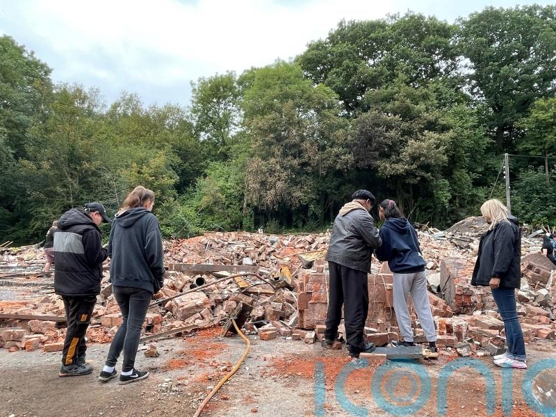 People gather at rubble of Crooked House to lament pub’s destruction