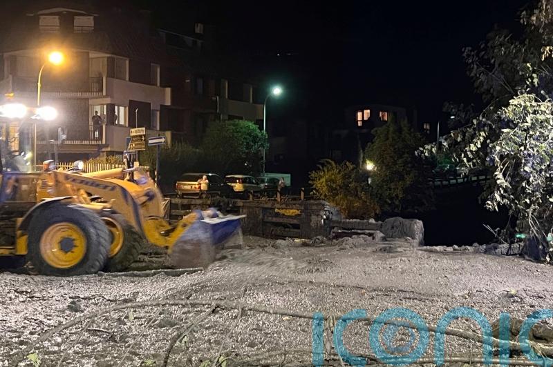 Crews clear streets after mudslide swamps town in Italian Alps