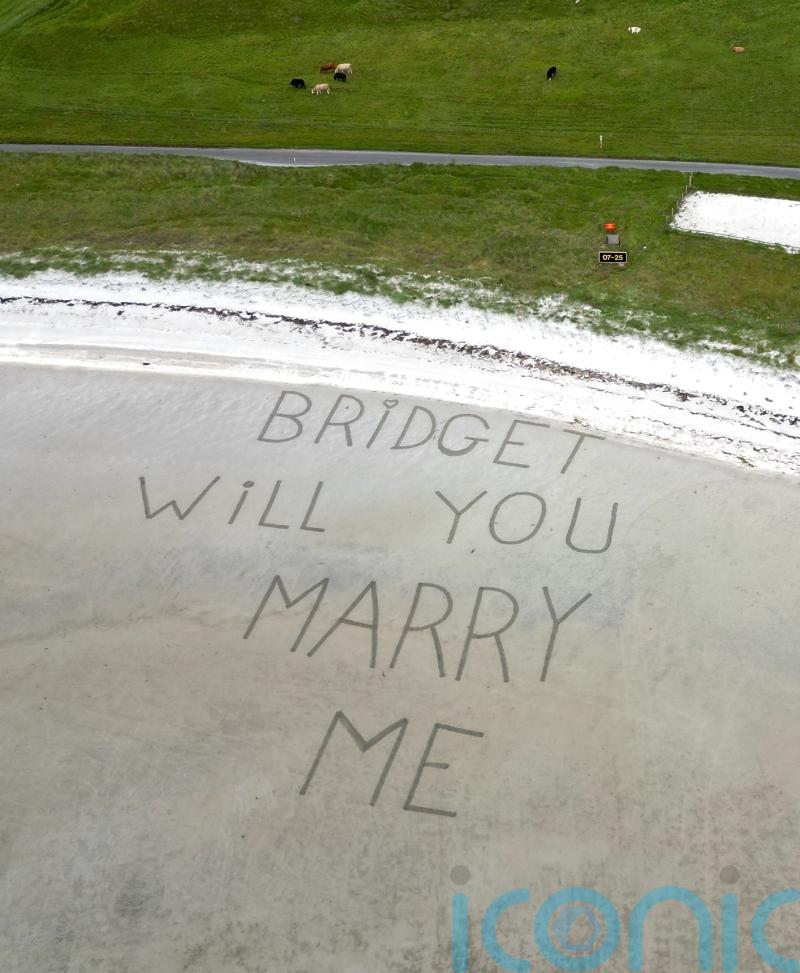 Marriage proposal etched into runway sand for man’s sky-high proposal