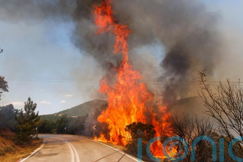 European crews join battle against wildfires that have left 20 dead in Greece