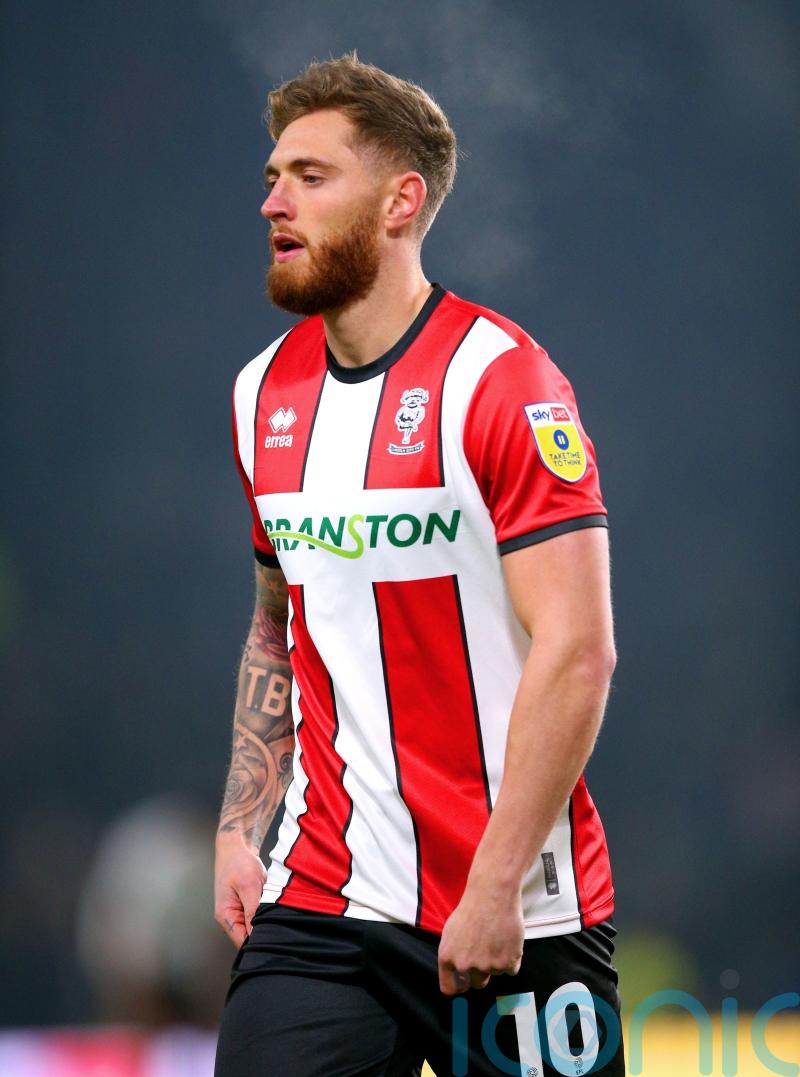 Lincoln move up to fourth with victory over 10-man Blackpool