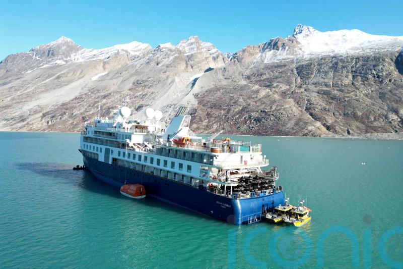 Luxury cruise ship stranded off Greenland is pulled free at high tide