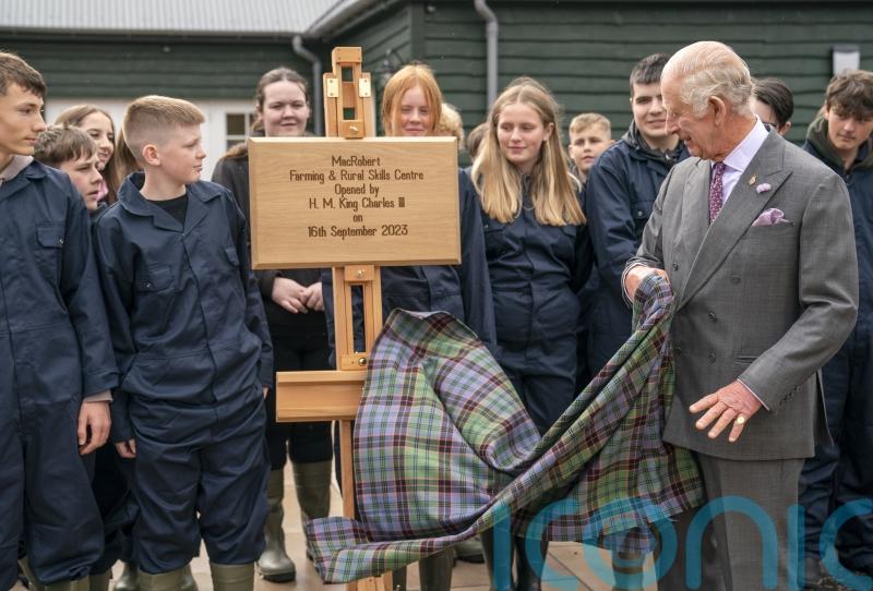 King meets pupils learning rural skills after helping to save estate