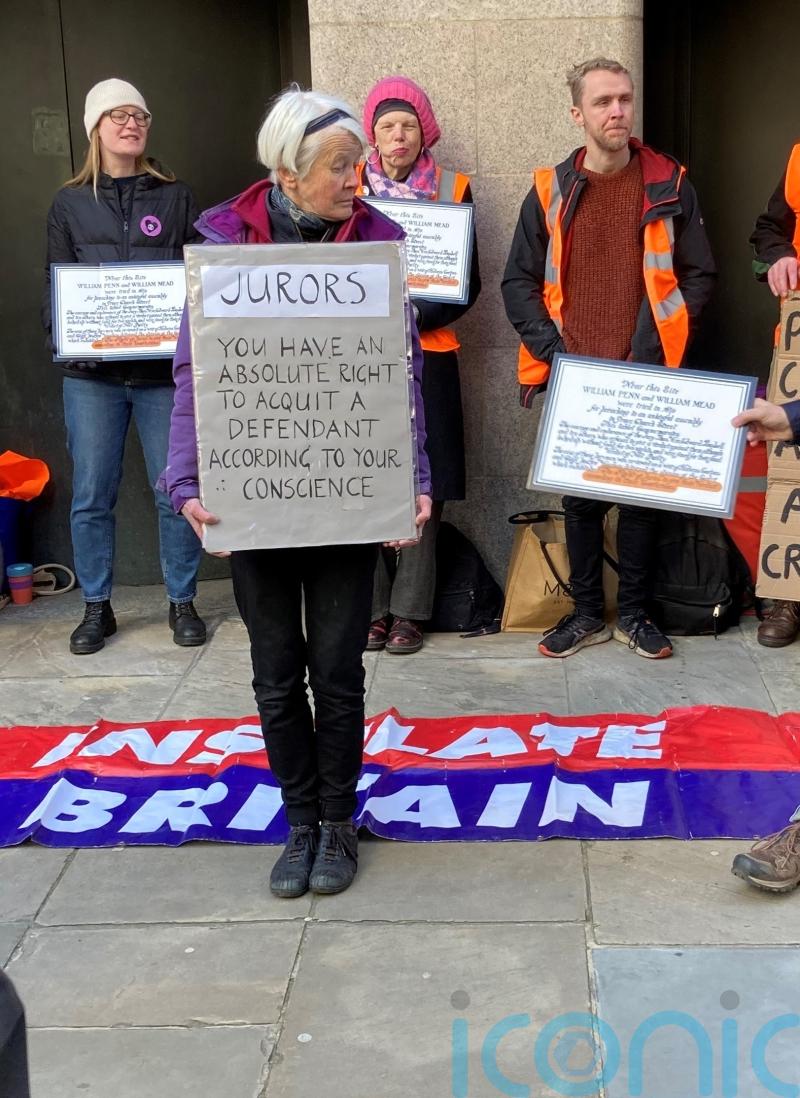 More than 250 climate activists protest with signs to jurors outside courts