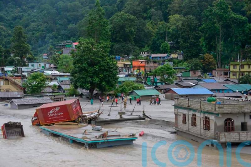 Flash floods kill at least 18 in India and leave nearly 100 missing