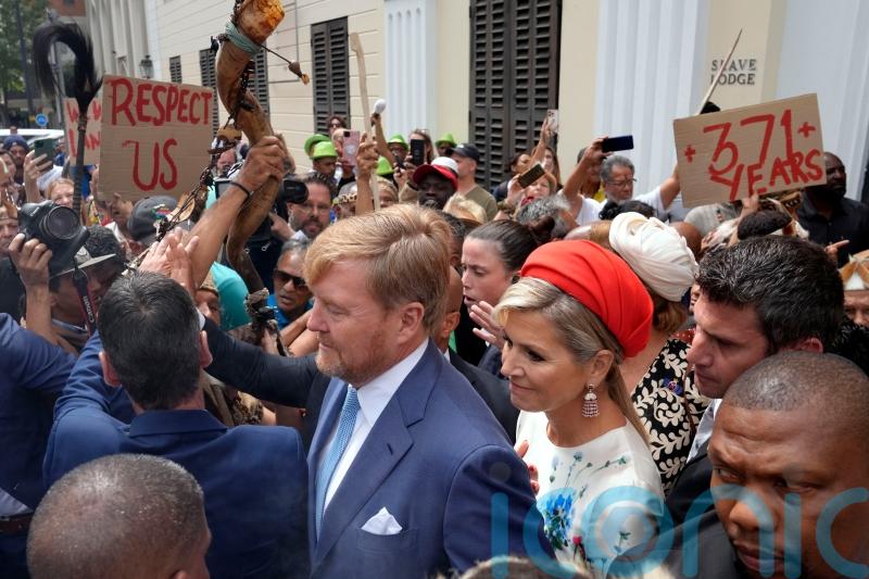 Dutch king and queen confronted by protesters during slavery museum visit