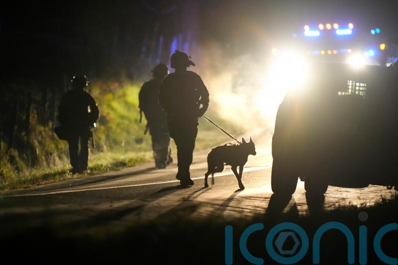 Heavily armed police surround home in search for Maine shooting suspect