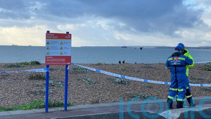 Beach cordoned off after discovery of body