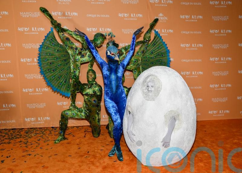 Queen of Halloween Heidi Klum recruits acrobats for peacock costume
