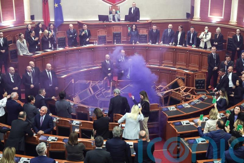 Opposition politicians throw firecrackers and chairs in parliament protest