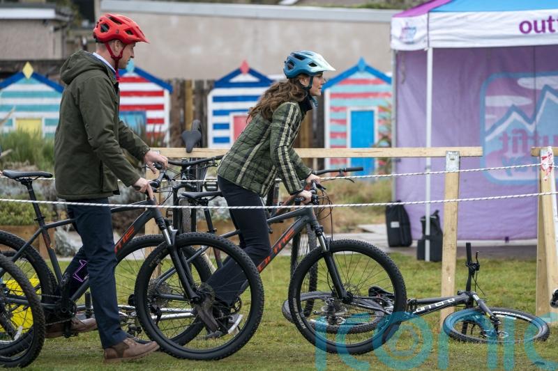 William and Kate cheered on as they show off bike skills