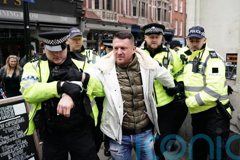 Tommy Robinson escorted from march against antisemitism as thousands gather
