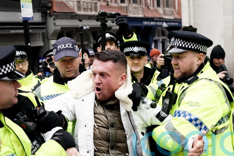 Tommy Robinson escorted from march against antisemitism as man arrested