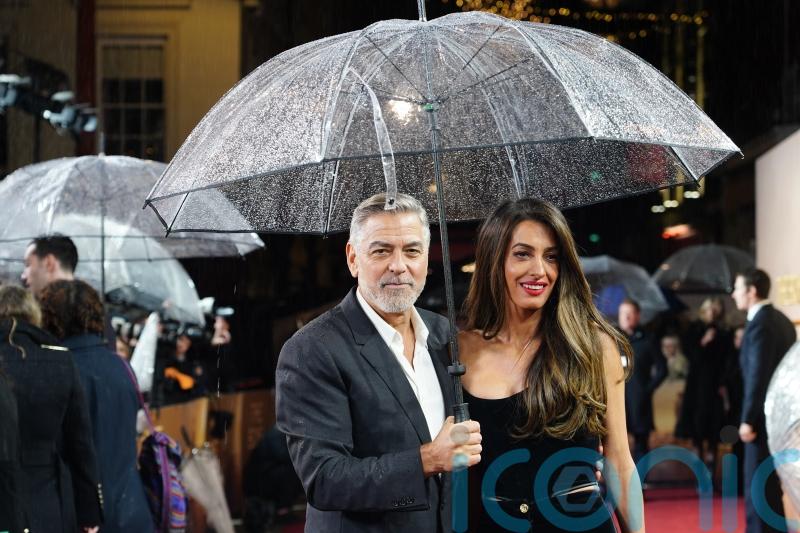 George and Amal Clooney brave British rain for screening of The Boys In The Boat