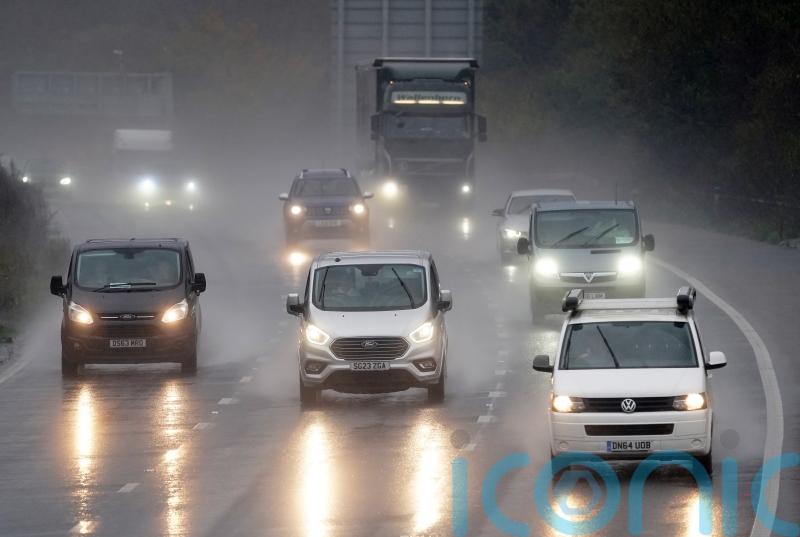 How can I stay safe when driving in heavy rain?
