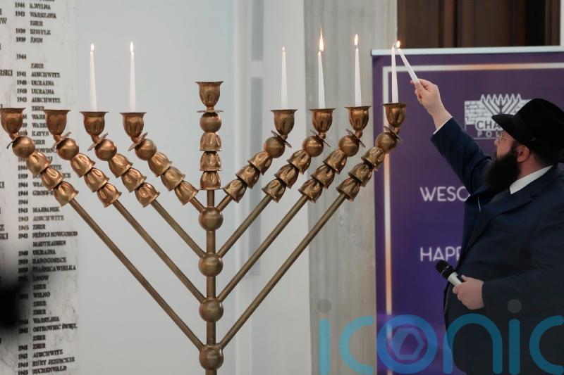 Far-right lawmaker extinguishes Hanukkah candles in Polish parliament