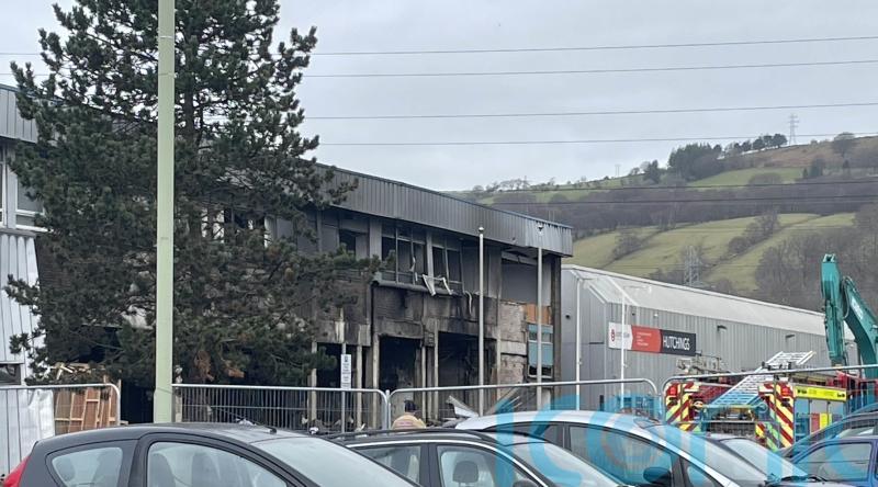 Flowers laid at industrial estate where person died following explosion and fire