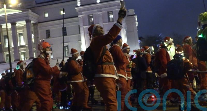 Skaters take over London streets wearing Santa outfits to provide festive cheer