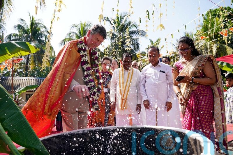 Princess Royal looks on as husband invited to smash coconut in temple visit