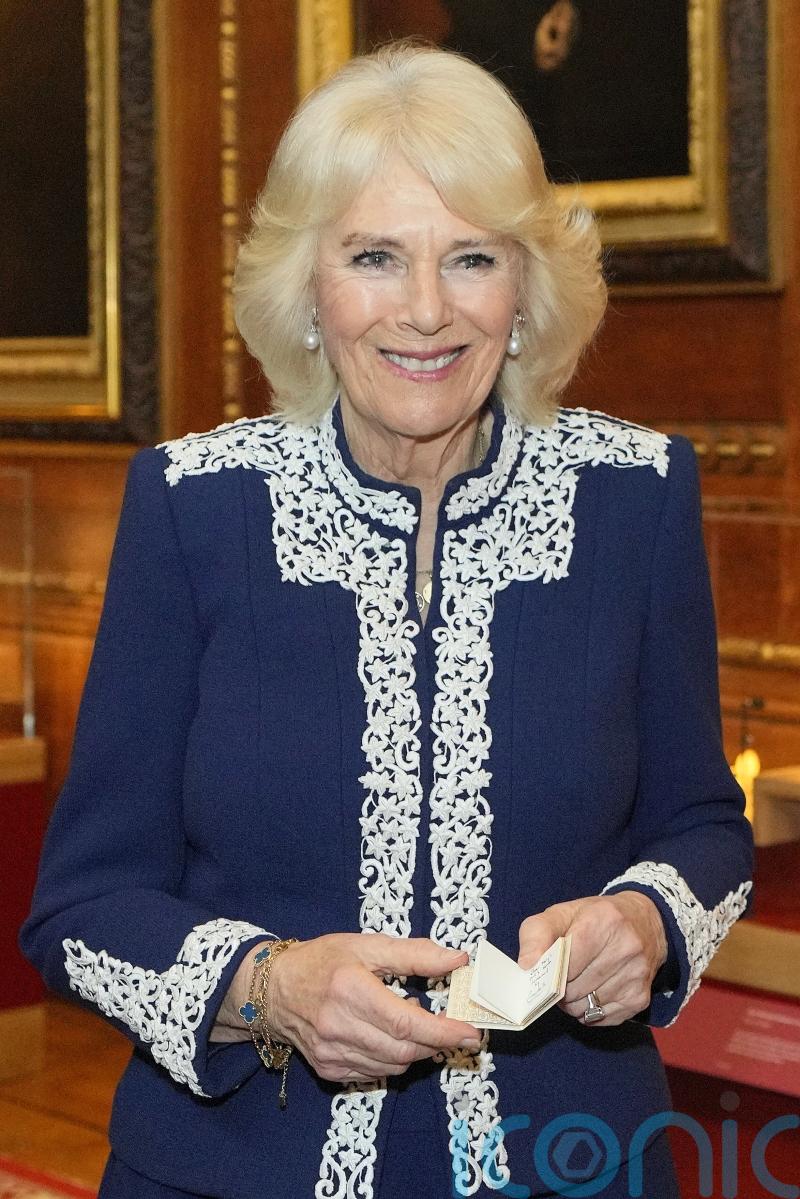 Camilla jokes about effect on sight of writing tiny book for royal dolls’ house