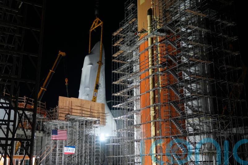Retired shuttle Endeavour is hoisted into launch position at new museum
