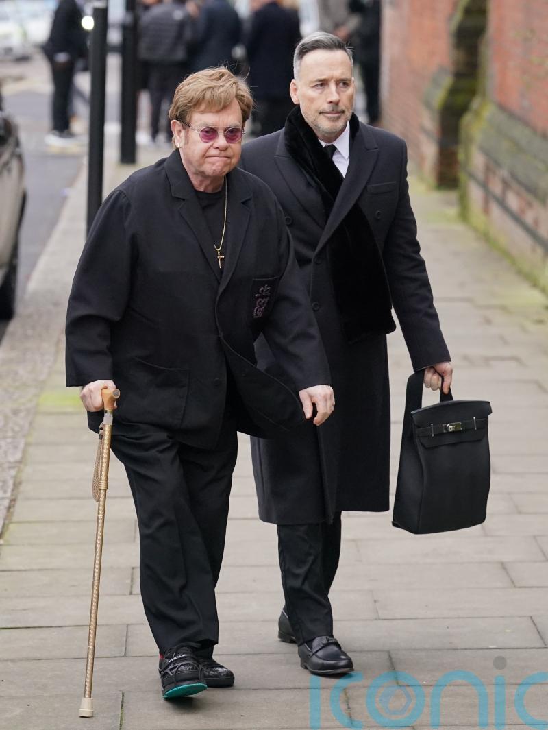 Sir Elton John and David Furnish attend funeral of Derek Draper
