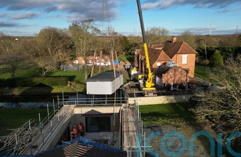 Crane lifts pool out of spa block at home of Captain Tom’s family