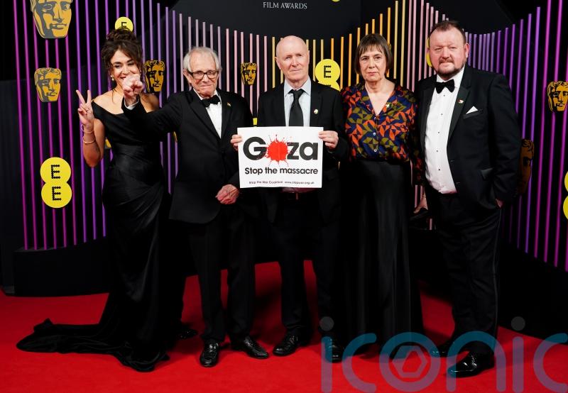 Veteran filmmaker Ken Loach poses at Baftas with sign calling for Gaza ceasefire