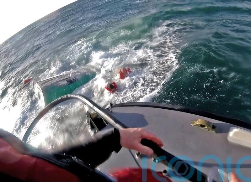 Four people rescued after fishing boat sinks