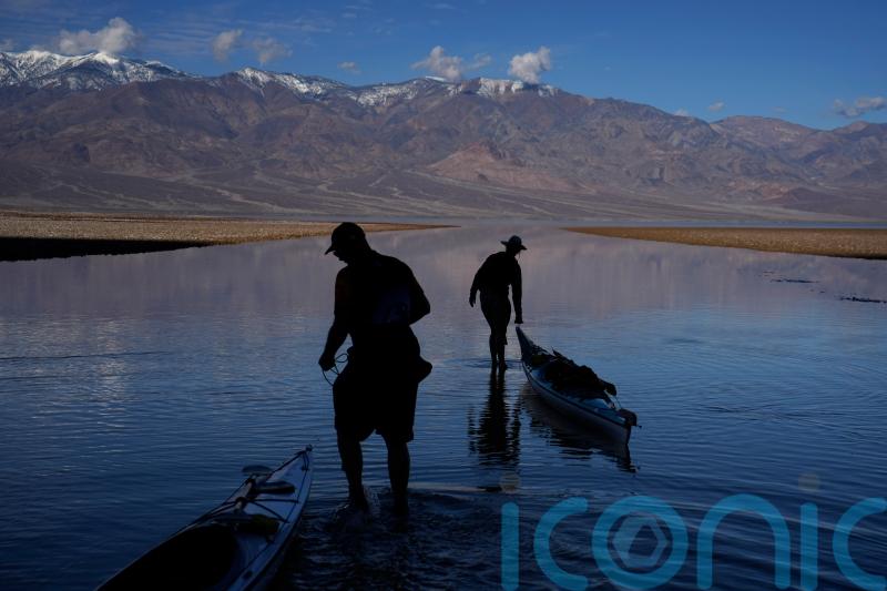 Kayakers paddle in one of Earth’s driest spots after rains replenish lake