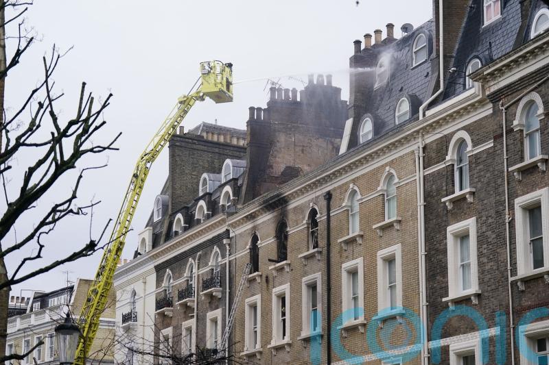 Eight police officers among 11 taken to hospital after fire at five-storey house