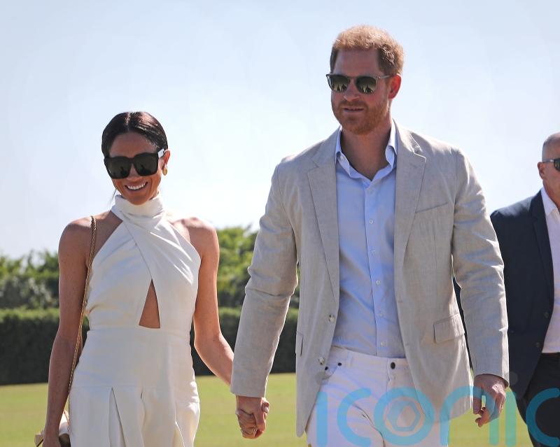 Harry and Meghan spotted hand in hand before charity polo match