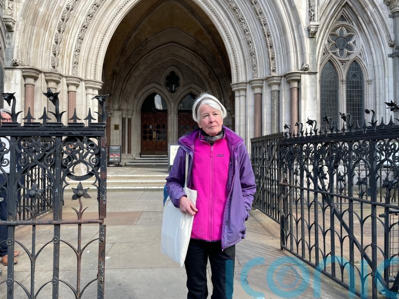 Protester committed contempt by holding sign for jurors to see, High Court told