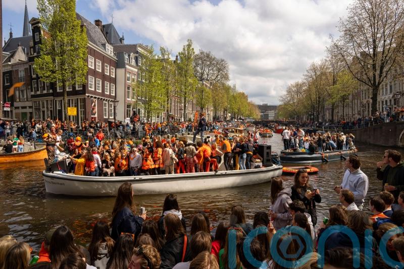 Revellers dress in orange to celebrate Dutch king’s birthday