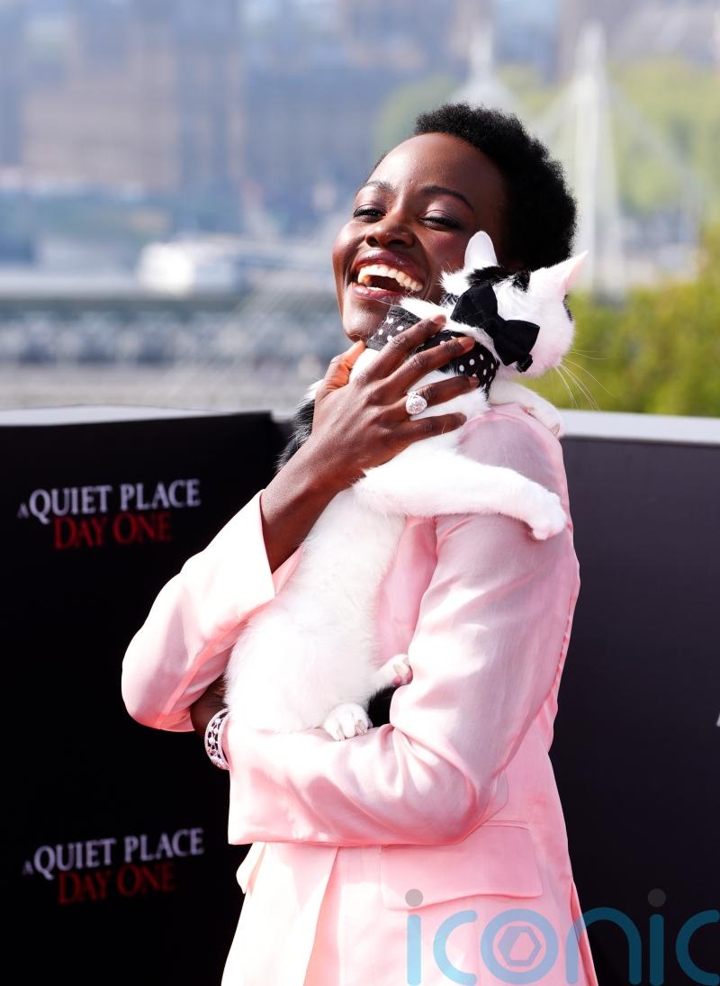 Lupita Nyong’o and feline friend pose while promoting A Quiet Place: Day One