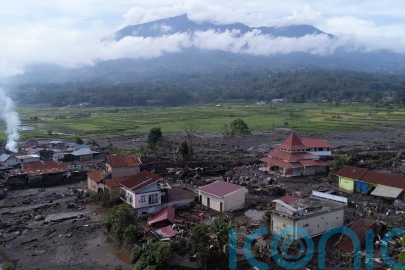 Indonesian rescuers search through rivers and rubble after flash floods