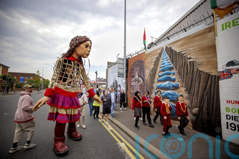 Little Amal meets schoolchildren from both sides of Belfast peace wall